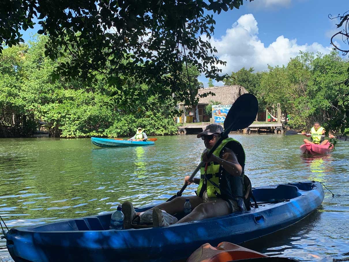 Guests kayaking a mangrove-lined channel on Fresh Water Creek Lagoon, Hopkins, Belize