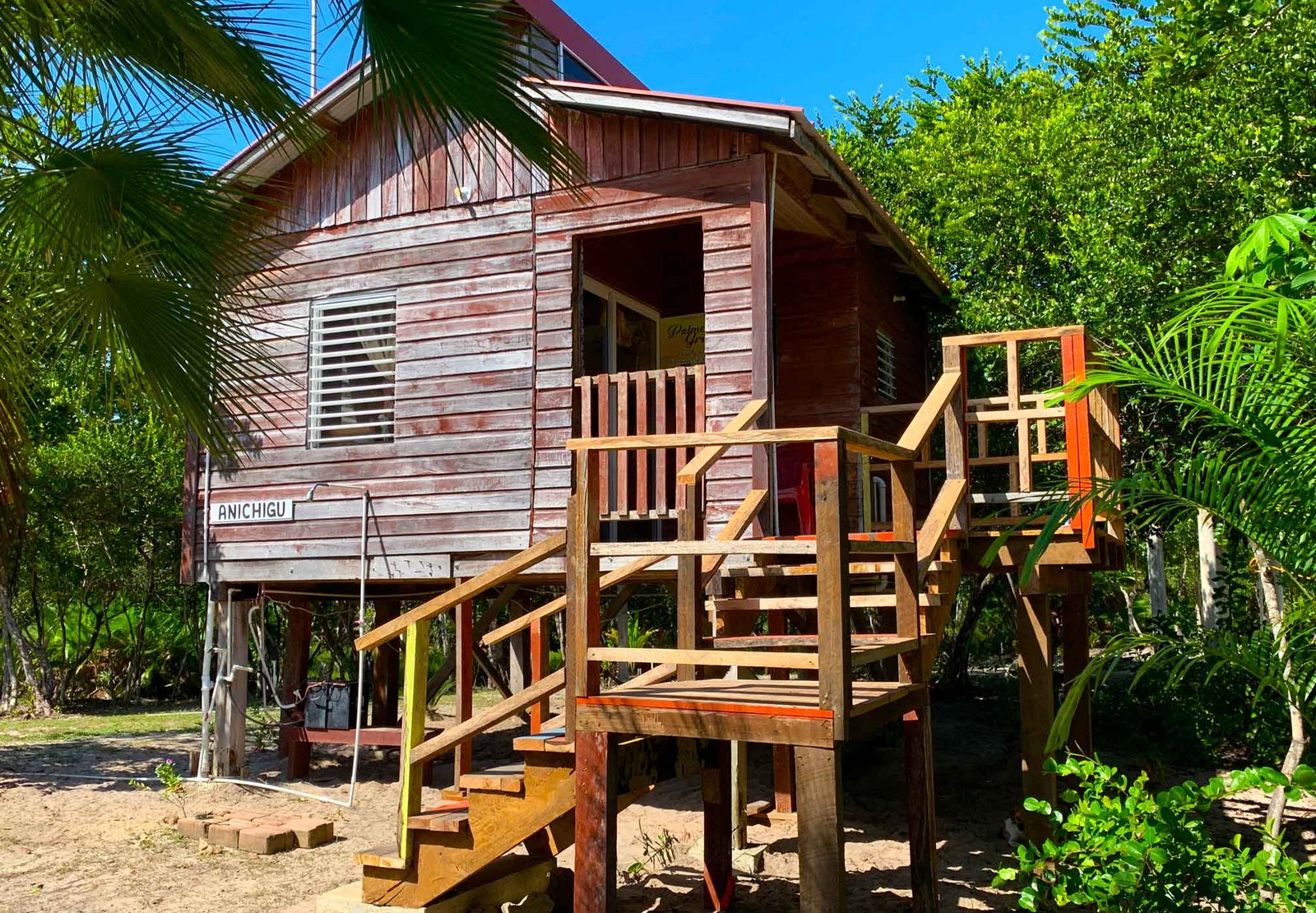 Anichigu, a solar-powered guest cabin on stilts at Palmento Grove, its name on a sign by the door
