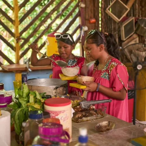 Guests serving themselves from the shared Garifuna meal at Palmento Grove, Hopkins, Belize