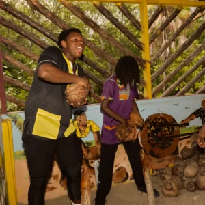 Guests husking coconuts together during a Garifuna cultural and culinary day at Palmento Grove