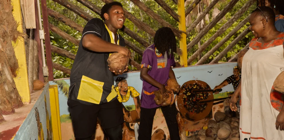 Guests husking coconuts together during a Garifuna cultural and culinary day at Palmento Grove