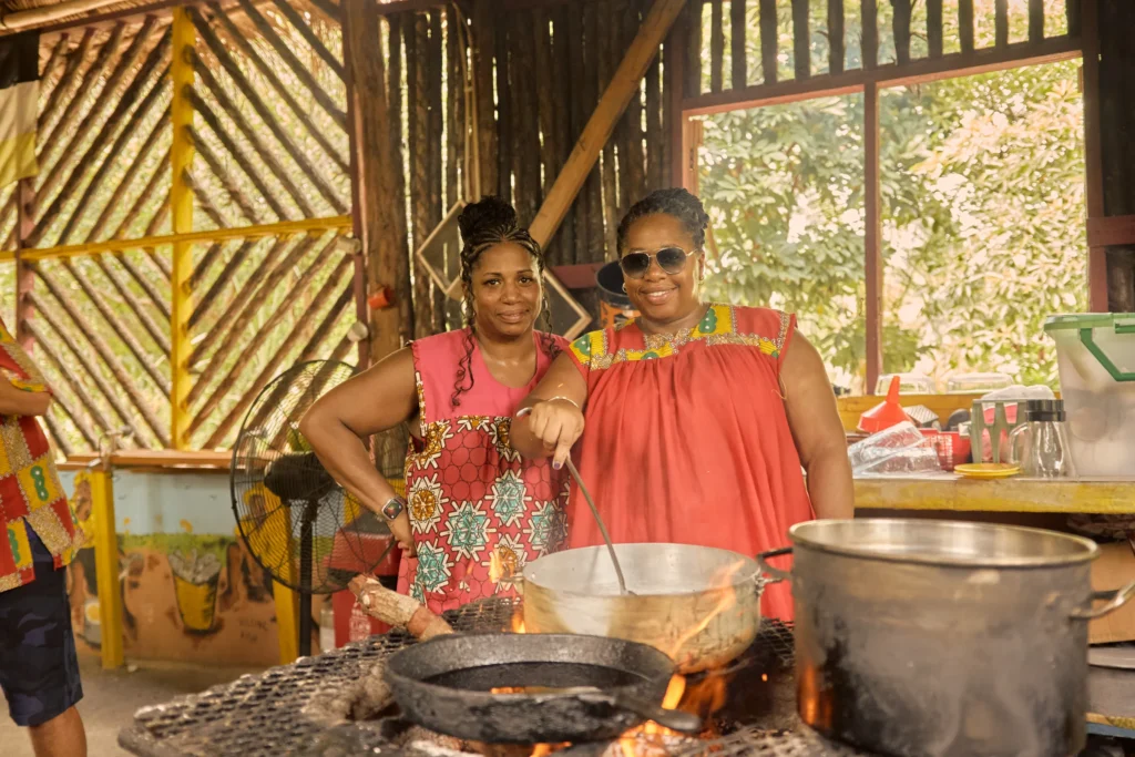 Guests cooking together over open fire pots at Palmento Grove