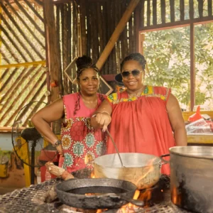 Guests cooking together over open fire pots at Palmento Grove