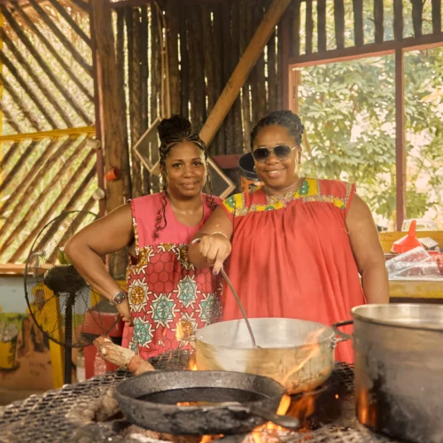 Guests cooking together over open fire pots at Palmento Grove