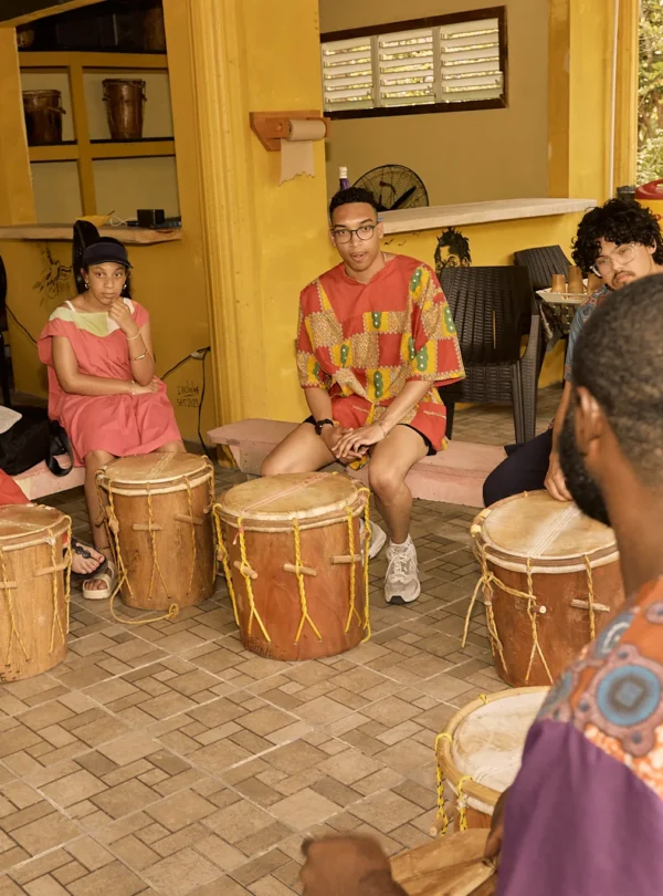 Guests seated at Garifuna drums during a drumming session at Palmento Grove, Hopkins, Belize