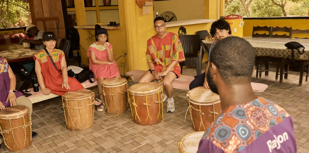 Guests seated at Garifuna drums during a drumming session at Palmento Grove, Hopkins, Belize