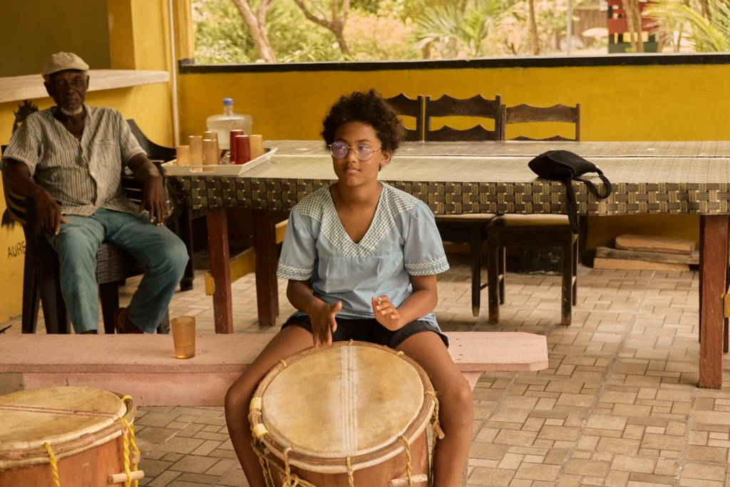 A group of guests drumming together in the music pavilion at Palmento Grove, Hopkins, Belize