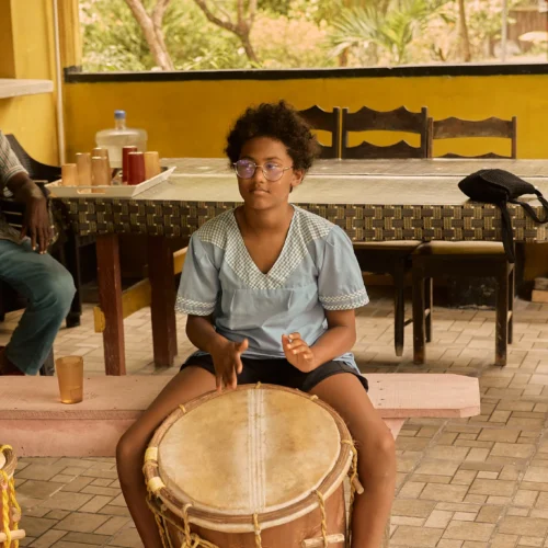 A group of guests drumming together in the music pavilion at Palmento Grove, Hopkins, Belize