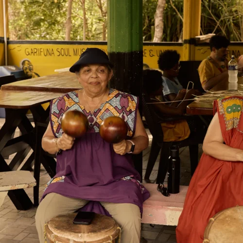 Guests seated at Garifuna drums in the pavilion at Palmento Grove, Hopkins, Belize