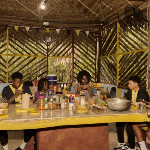Guests sharing a Garifuna meal together at the long table at Palmento Grove