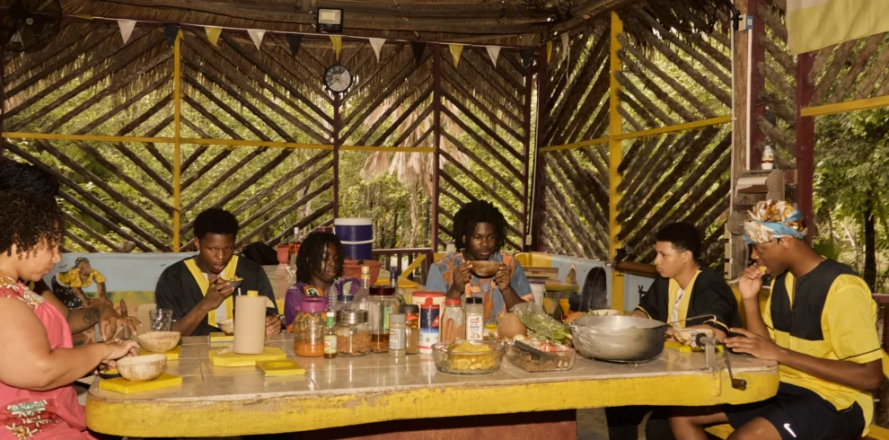Guests sharing a Garifuna meal together at the long table at Palmento Grove