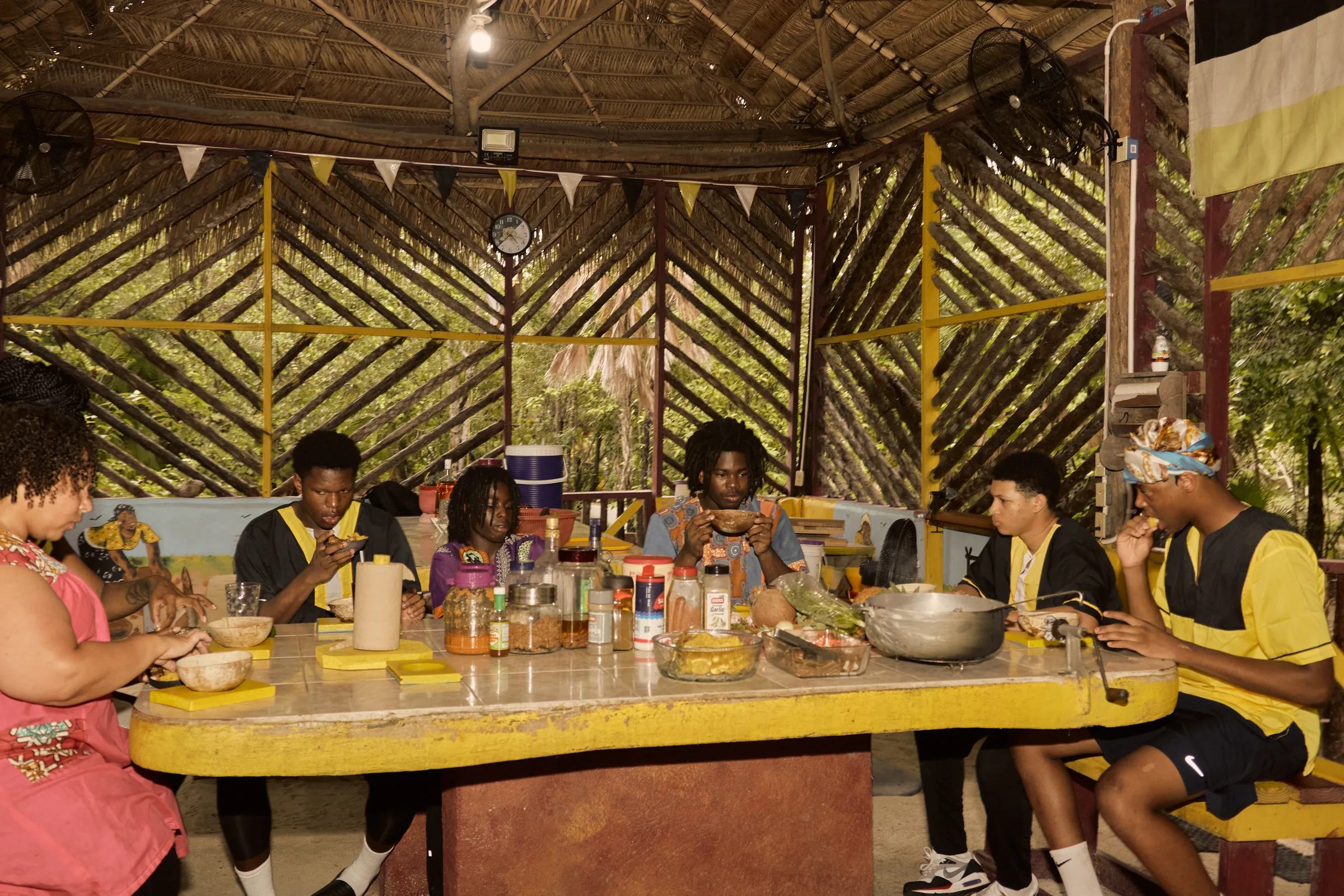 Guests sharing a Garifuna meal together at the long table at Palmento Grove