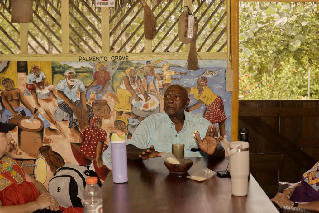 A Garifuna elder speaking with visitors at Palmento Grove, Hopkins, Belize