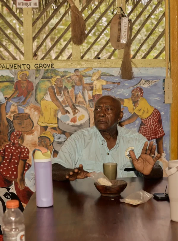 A Garifuna elder speaking with visitors at Palmento Grove, Hopkins, Belize