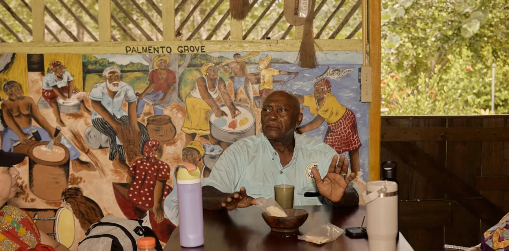 A Garifuna elder speaking with visitors at Palmento Grove, Hopkins, Belize