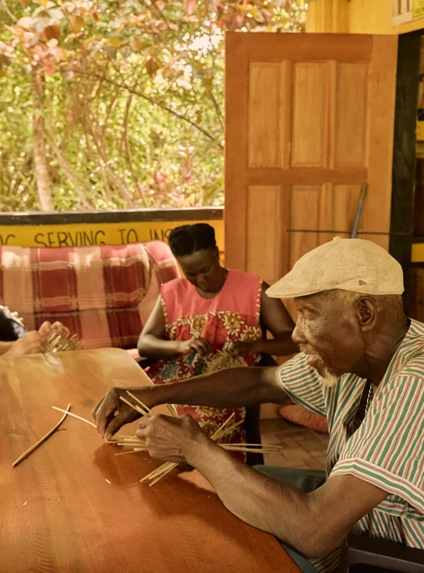 Guests learning basket weaving at the long table at Palmento Grove, Hopkins, Belize