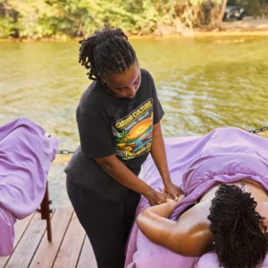 A massage under the red-and-yellow pavilion at Palmento Grove, Hopkins, Belize